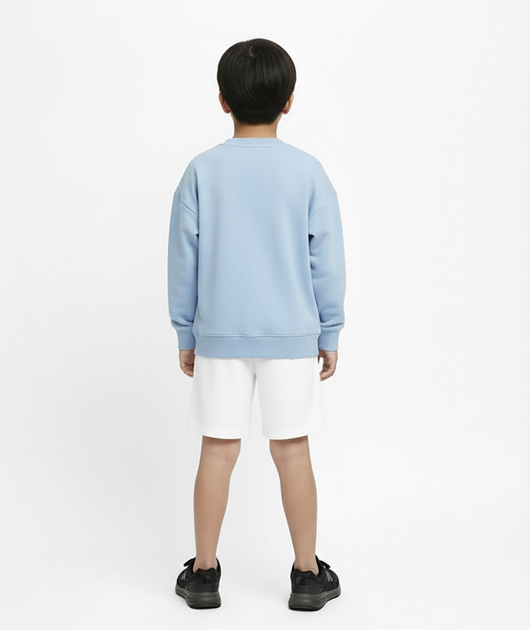 Back view of boy wearing Goldencubs baby blue cotton sweatshirt and white shorts — soft, breathable, and modern athleisurewear for kids.