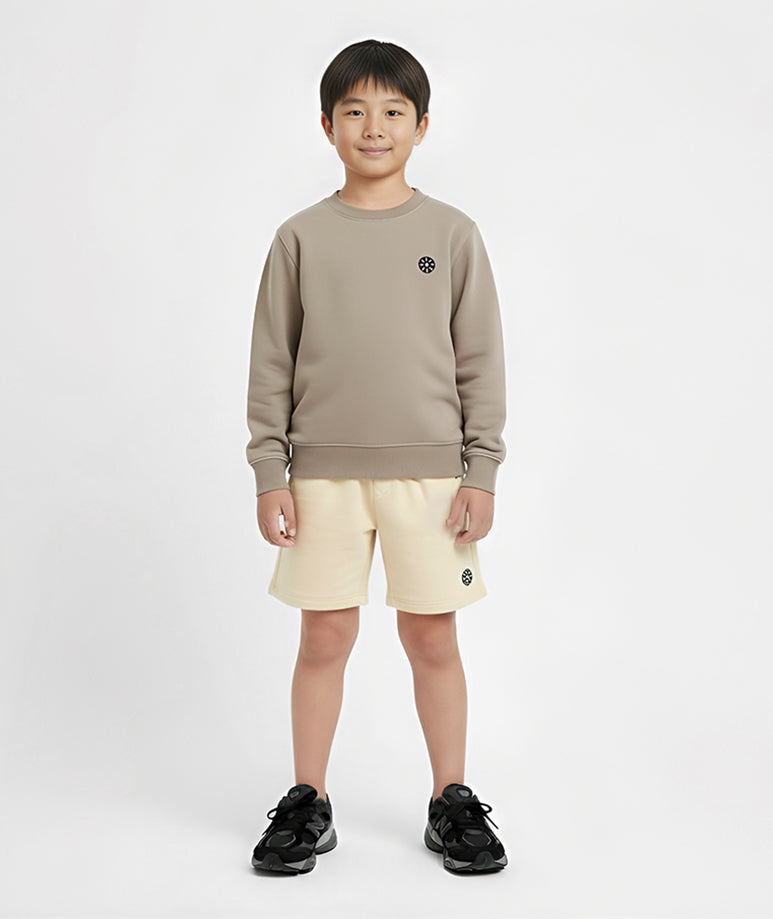 Front view of boy wearing Goldencubs cream cotton boys shorts and taupe sweatshirt — comfortable, stylish, and soft cotton summer look.