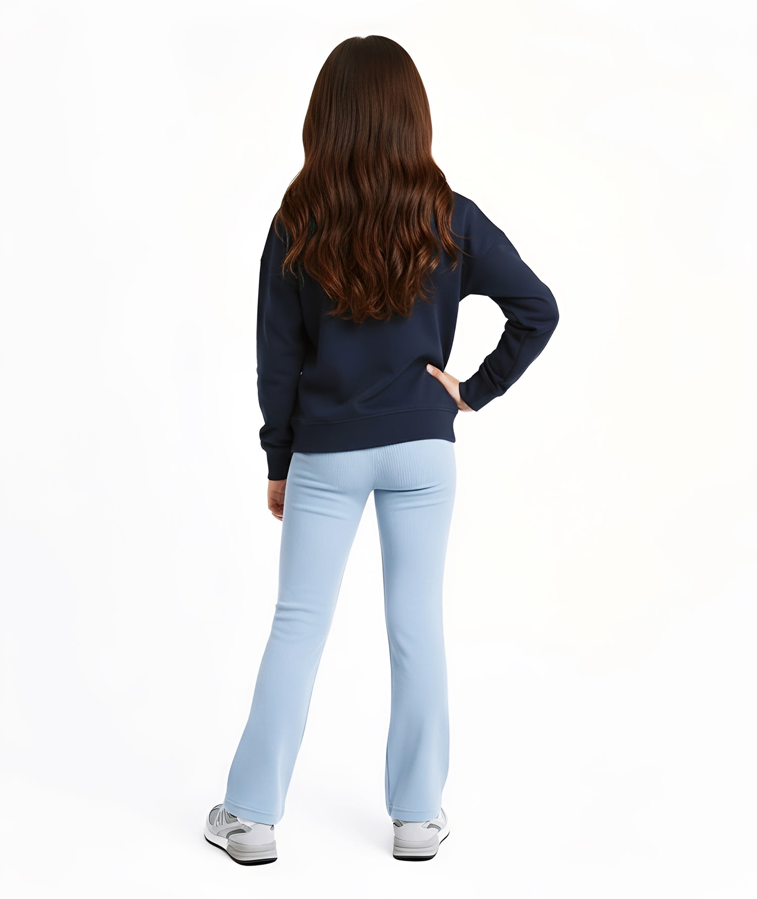 Back view of girl wearing Goldencubs navy cotton long sleeve T-shirt, styled with light blue flared pants.