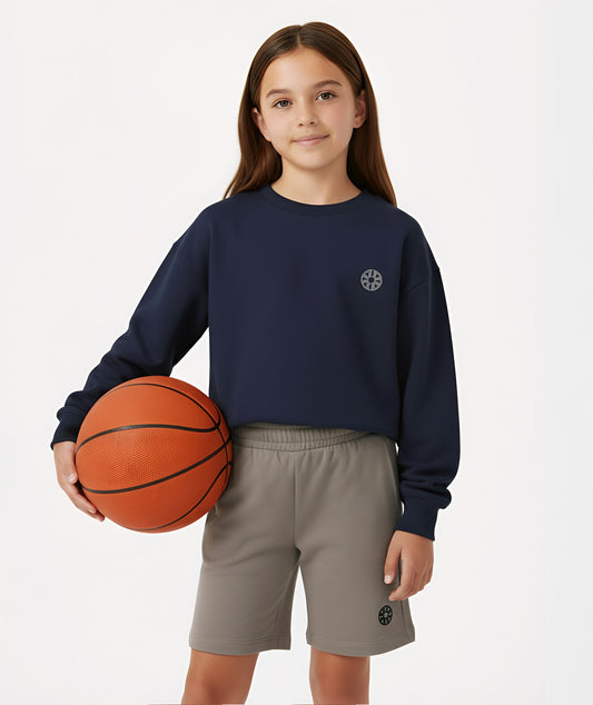 Girl posing with basketball in Goldencubs navy cotton sweatshirt, highlighting sporty and casual style.