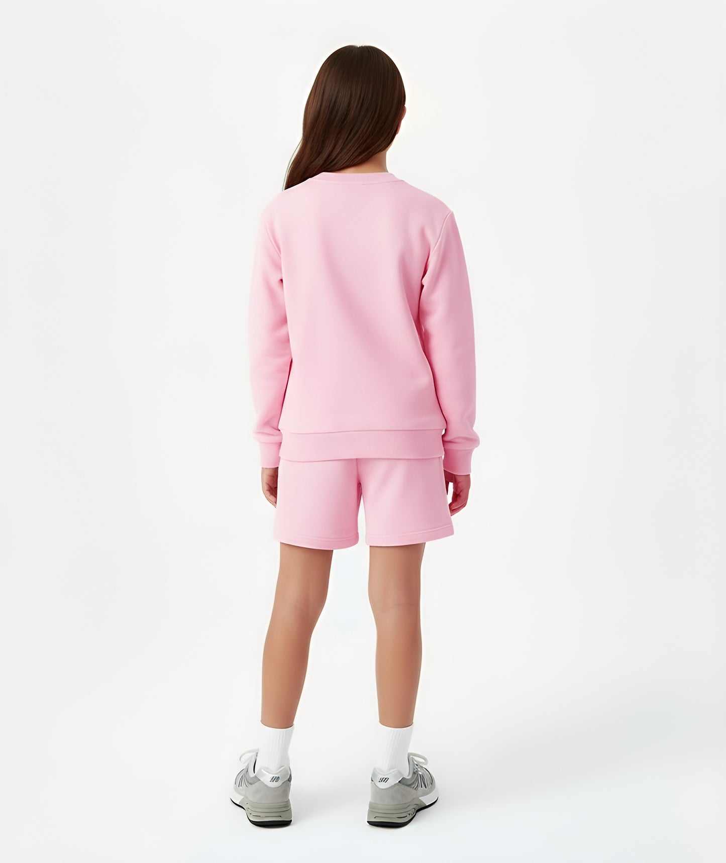 Back view of girl wearing Goldencubs pink cotton sweatshirt, showing relaxed fit and ribbed cuffs.