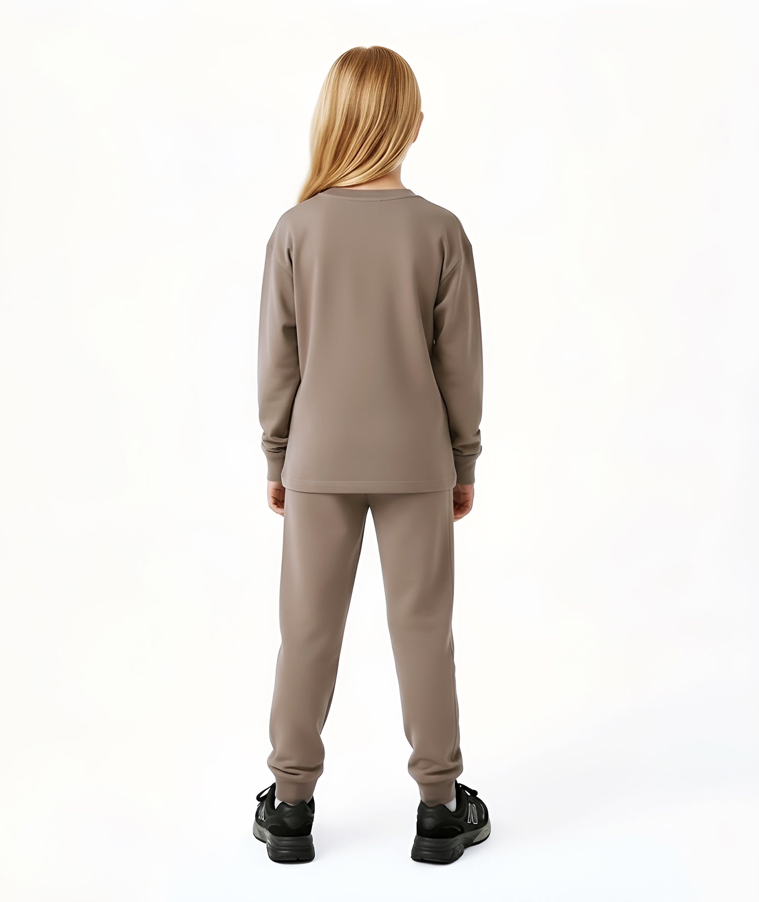 Back view of girl wearing Goldencubs taupe cotton sweatpants, showing relaxed fit and elastic waistband.