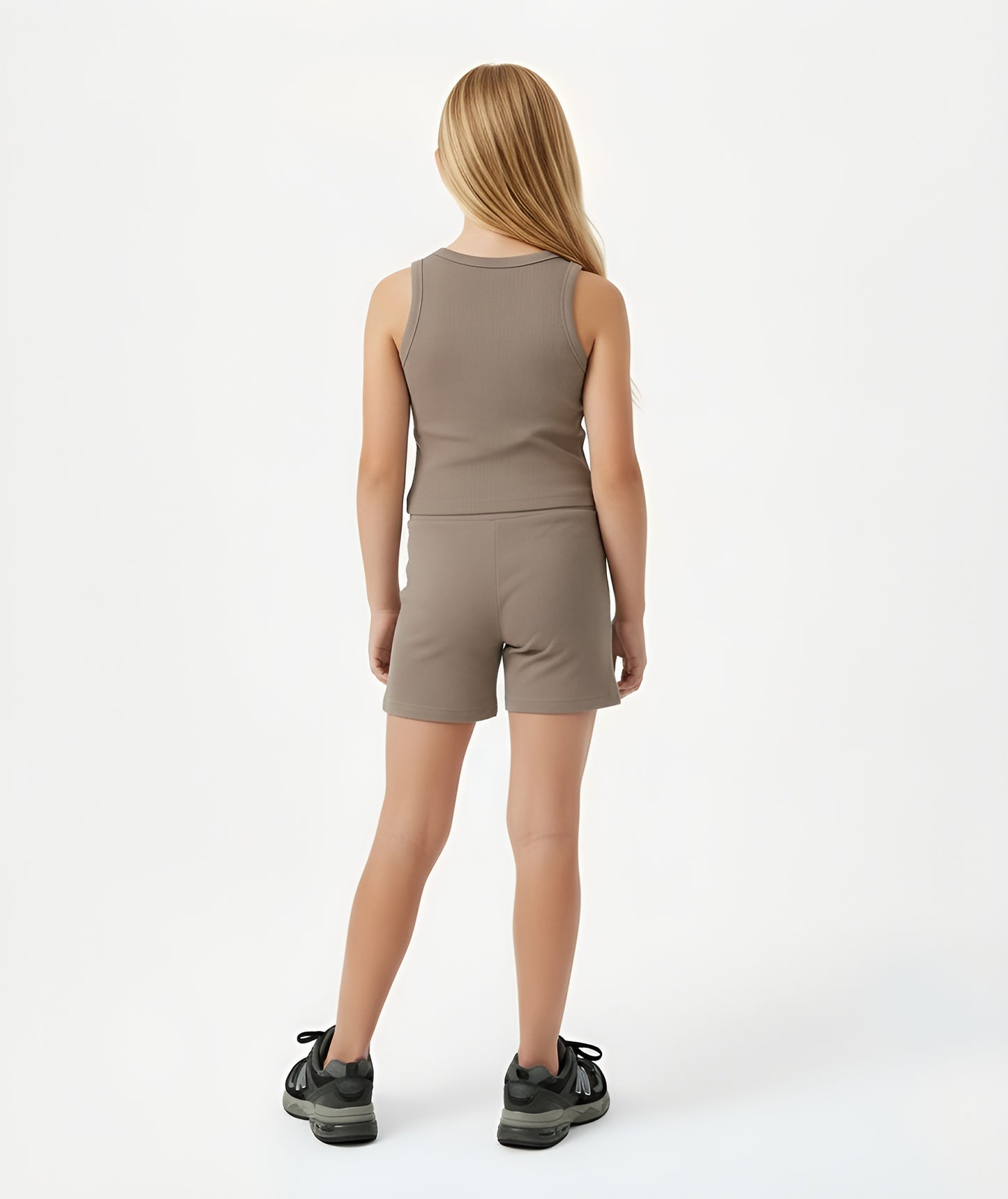 Back view of girl wearing Goldencubs taupe cotton tank top, showing clean racerback design and smooth ribbed texture.