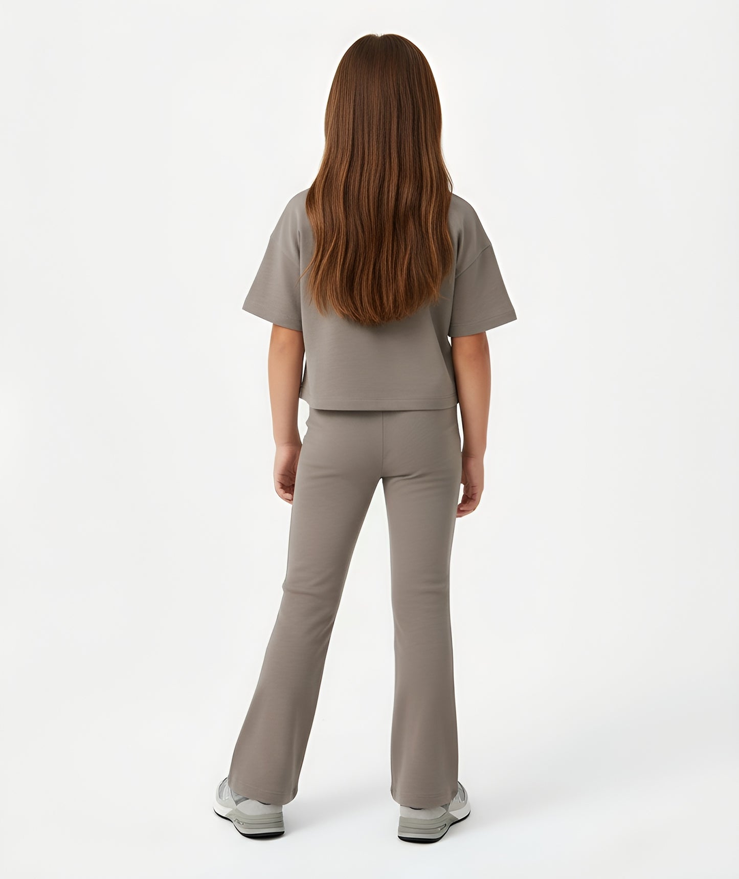 Back view of girl wearing Goldencubs taupe cotton T-shirt, showing relaxed cropped fit and smooth texture.