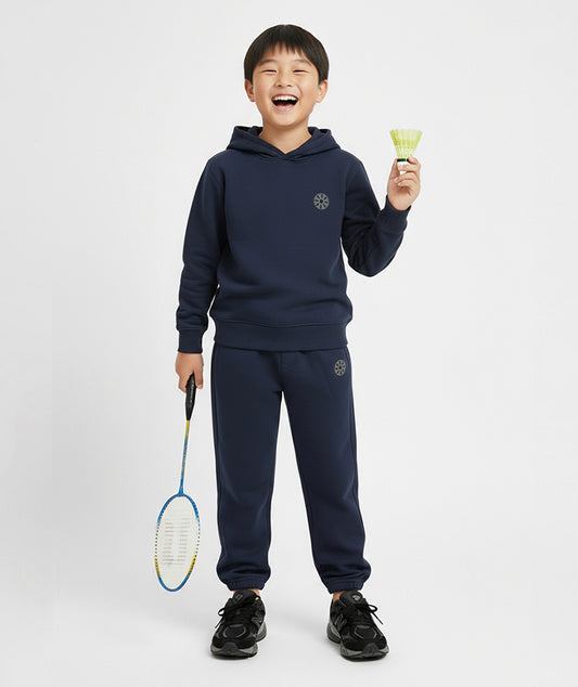 Front view of boy wearing Goldencubs navy cotton sweatpants with elastic cuffs and logo patch — versatile and breathable sportswear for kids.