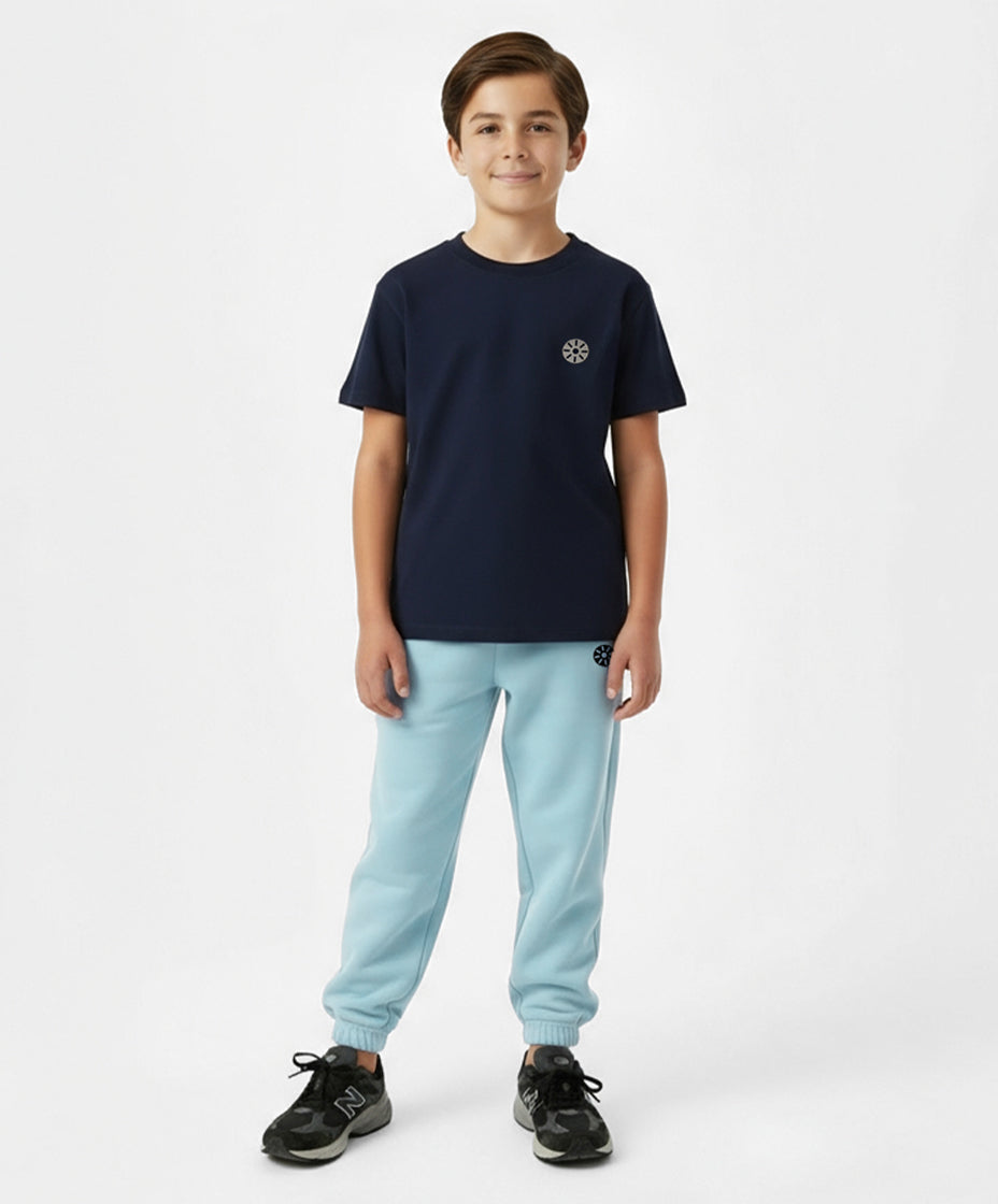 Front view of boy wearing Goldencubs navy cotton T-shirt and light blue sweatpants — soft, breathable, and stylish everyday kidswear.