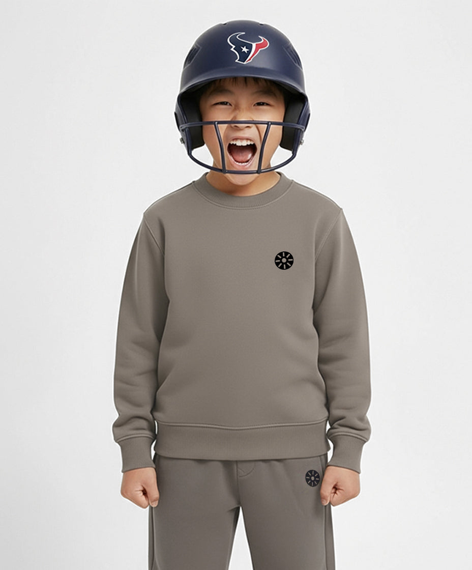 Boy wearing Goldencubs taupe cotton sweatshirt and helmet, smiling confidently — stylish and durable kids sportswear with premium comfort.