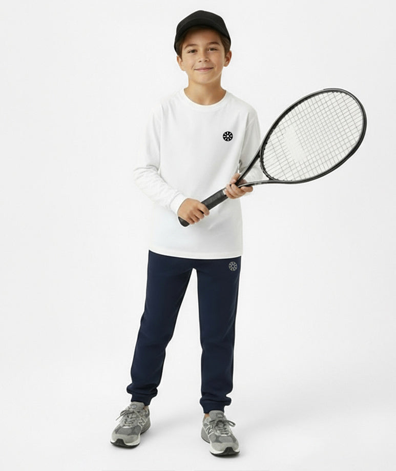 Front view of boy wearing Goldencubs white cotton long sleeve T-shirt and navy sweatpants while holding a tennis racket — active and stylish look.