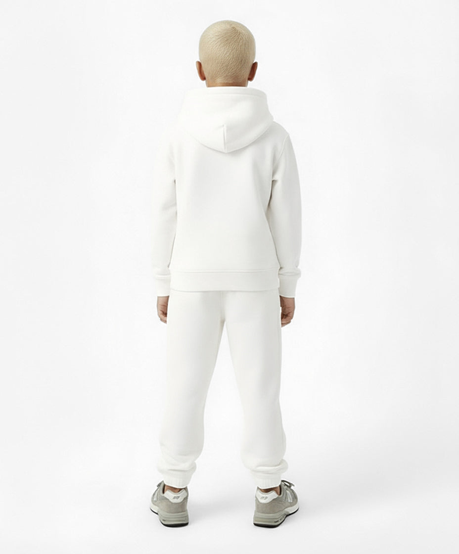 Back view of boy wearing Goldencubs white cotton sweatpants and matching hoodie — sporty and cozy kids loungewear look.