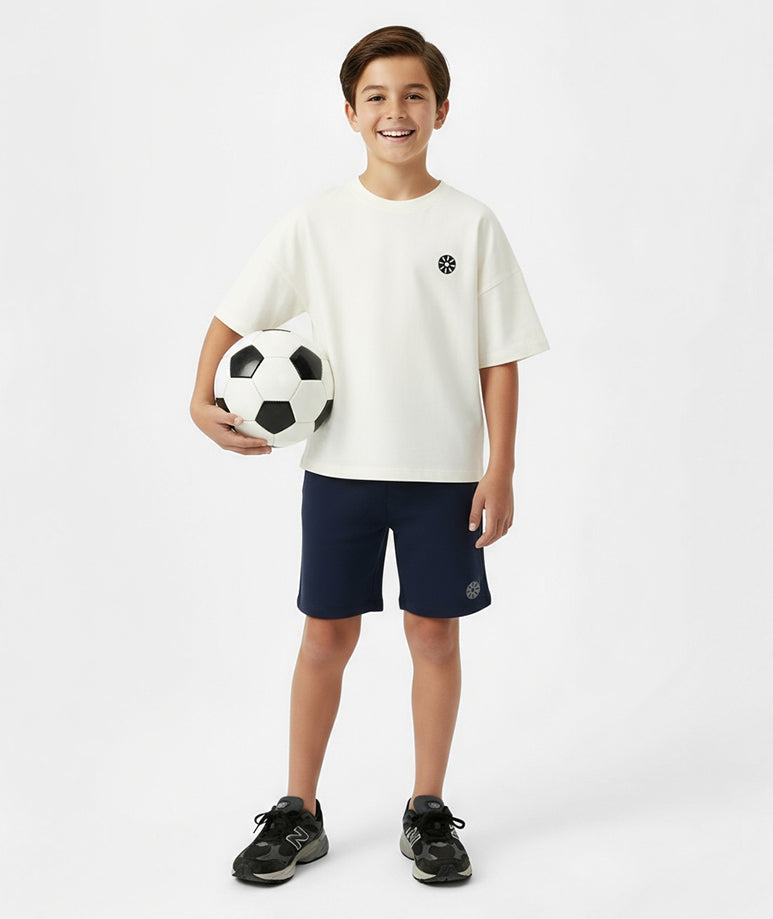 Front view of boy wearing Goldencubs white cotton t-shirt and navy shorts — sporty, comfortable, and stylish everyday look.