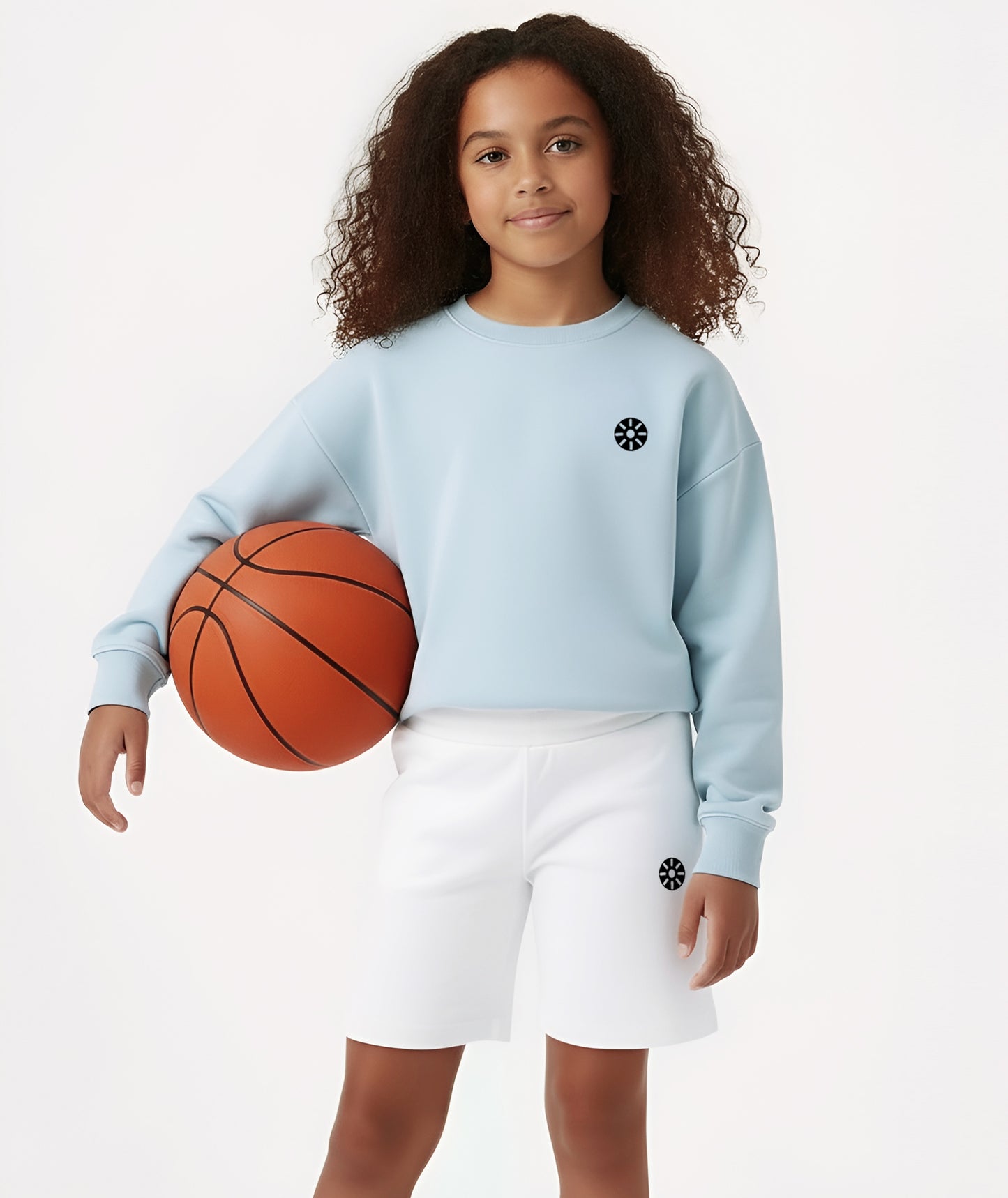 Close-up of Goldencubs girls baby blue cotton sweatshirt featuring a minimalist logo, showcasing the smooth cotton texture and modern athleisure design.