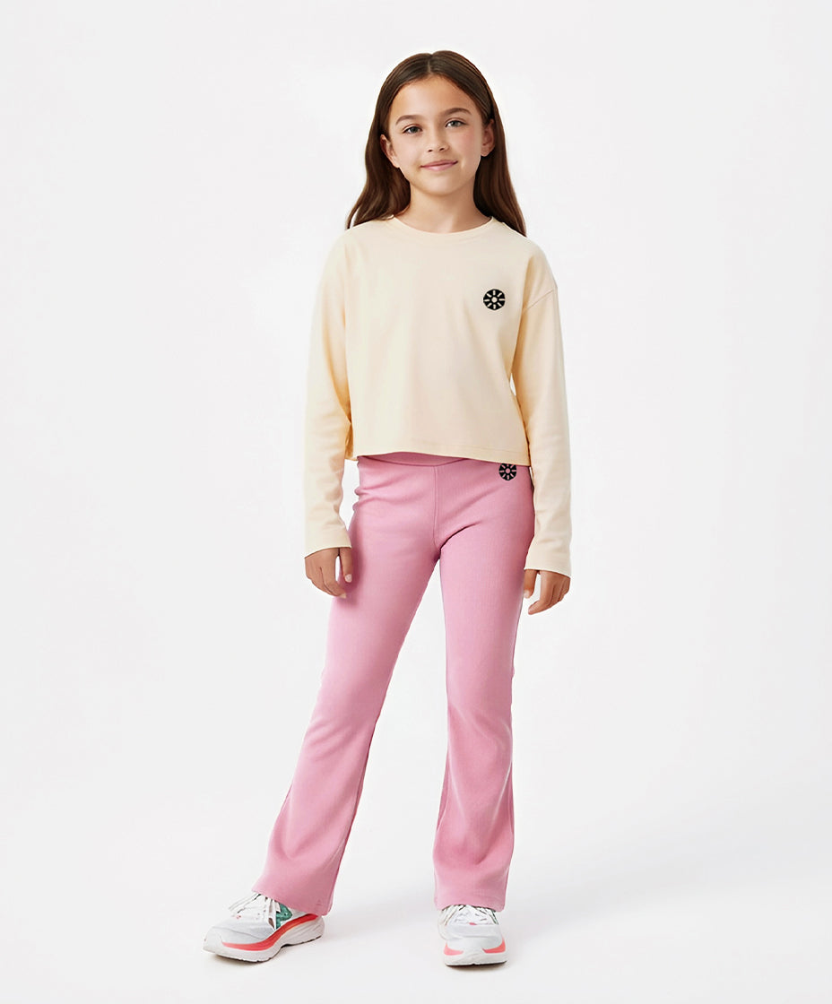 Close-up of Goldencubs girls cream cotton long sleeve T-shirt with signature logo detail, showcasing the smooth texture and minimalist athleisure design.