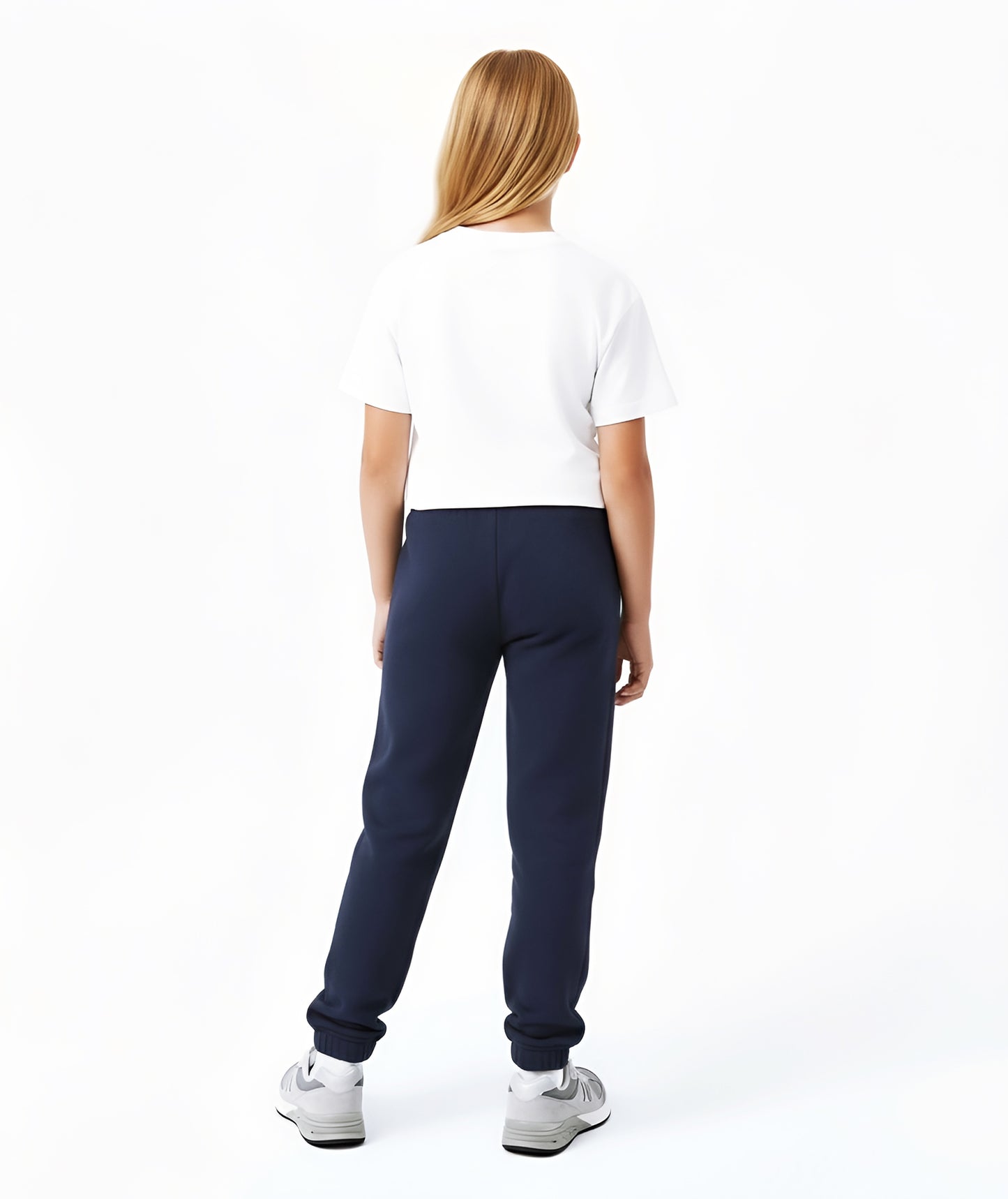 Rear view of Goldencubs girls white cropped cotton T-shirt with navy pants, showing the relaxed fit, soft texture, and minimalist sporty silhouette.